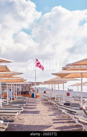 Kemer, Turkey - May, 21: Beach view of sunbeds, coast, sea on a bright sunny day. Turkish beach with Turkey flag. High quality photo Stock Photo