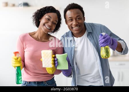 Cheerful african american lovers enjoying house-keeping, closeup Stock Photo