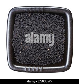 top view of Nigella sativa seeds (black caraway) in black bowl isolated on white background Stock Photo