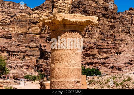 Close up of limestone capital with elephant heads on a column, symbolizing power and protection, with rock formations in background, petra, jordan Stock Photo