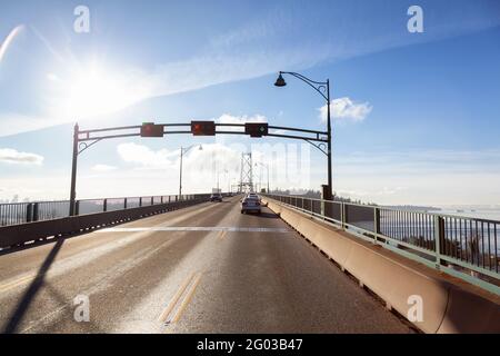 Drive across the famous Lions Gate Bridge in the modern Downtown City. Stock Photo