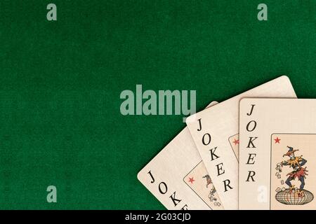 Playing cards on green backdrop of table in casino. Picture with free place for user text or picture. Stock Photo