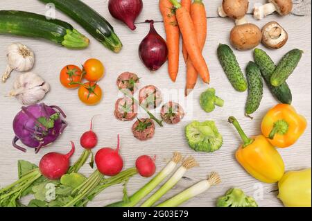 Abstract Raw Beef And Pork Meatballs Forming BunchTomatoes and fresh vegetables Stock Photo