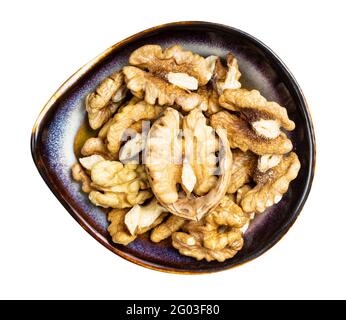 top view of shelled walnuts in ceramic bowl isolated on white background Stock Photo