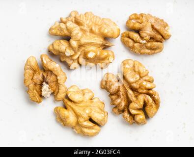 several shelled walnuts close up on gray ceramic plate Stock Photo