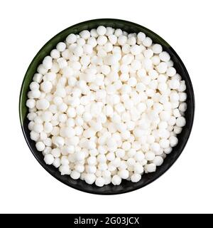 dry sabudana (tapioca sago) in wooden spoon isolated on white ...