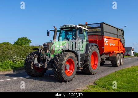 Fendt Tractor, Ktwo Roadeo Curve range of tipping silage trailers, used for grass cutting in Cheshire, UK Stock Photo