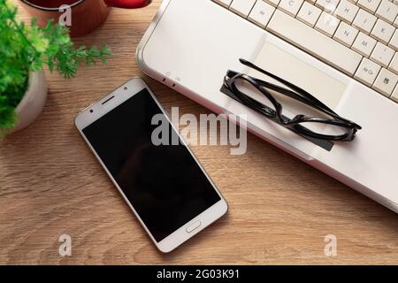 top view of mobile phone on desktop Stock Photo