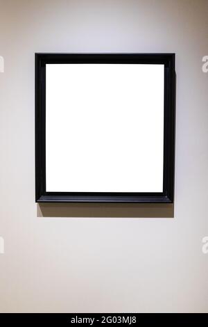 square black picture frame with cutout canvas on gray vertical wall Stock Photo