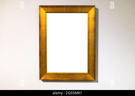 vertical wide flat golden picture frame with cutout canvas on horizontal wall Stock Photo