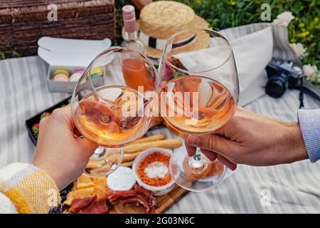 Couple clinking with two glasses of rose wine. Stock Photo