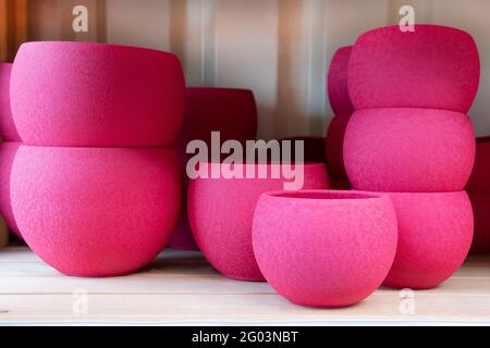 Empty garden Ceramic Decorate fuchsia color Pots in a row on the shelf in the hardware store. Spring shopping Gardening concept Stock Photo