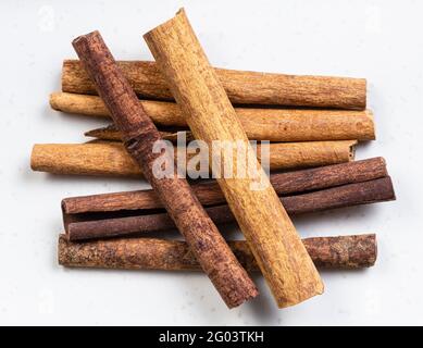 top view of cassia (chinese cinnamon) quills close up on gray ceramic plate Stock Photo