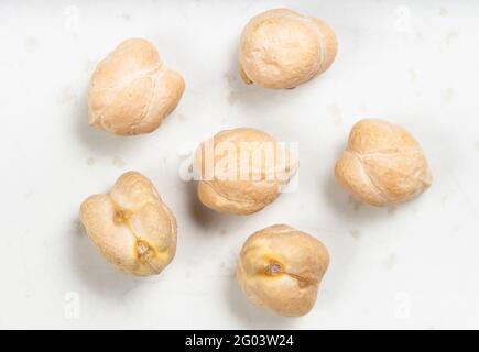 several raw dried chickpea seeds close up on gray ceramic plate Stock Photo