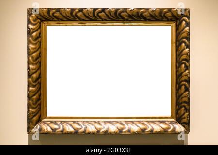 old carved wide bronze picture frame with cutout canvas on yellow brown wall Stock Photo