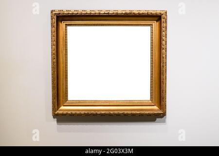 old wide golden picture frame with cutout canvas on gray wall Stock Photo