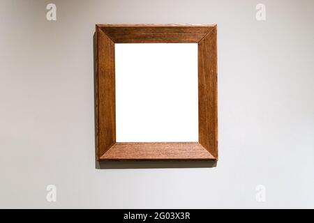 flat wide vertical wooden picture frame with cutout canvas on gray wall Stock Photo