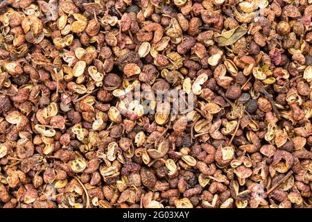food background - many dried pink sichuan peppercorns Stock Photo