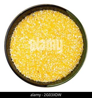 top view of coarse cornmeal in round bowl isolated on white background Stock Photo