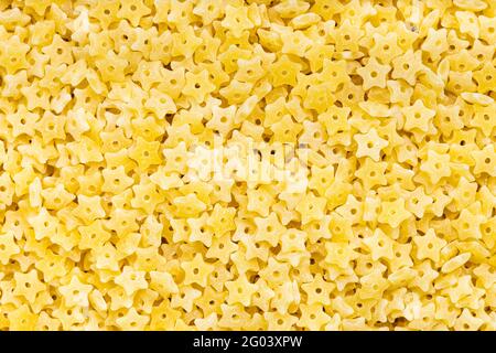 food background - uncooked dry stelline pastina Stock Photo