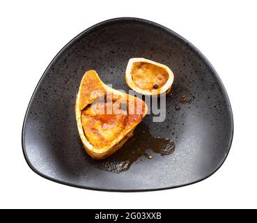 top view of barebones with marrow on black plate solated on white background Stock Photo