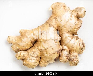 natural fresh whole ginger root on gray plate close up Stock Photo
