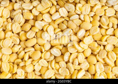 food background - many raw moong dal (split green mung) beans close up Stock Photo