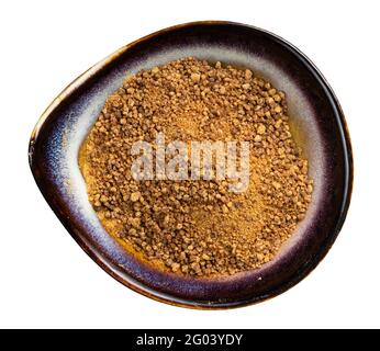 top view of granulated coconut blossom sugar in ceramic bowl isolated on white background Stock Photo