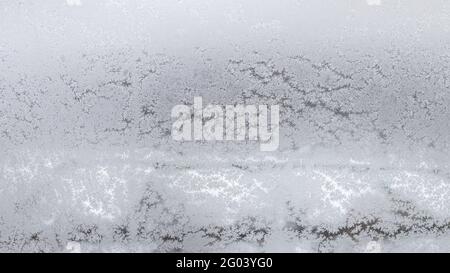 frosted home window in urban houses in city on overcast winter day (focus on the surface on windowpane) Stock Photo