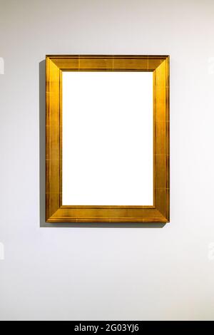 vertical wide flat golden picture frame with cutout canvas on vertical wall Stock Photo