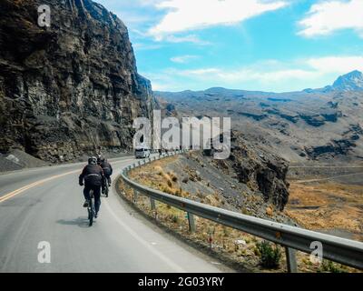 Mountain bikers riding the famous downhill trail Road of death in Bolivia. Stock Photo