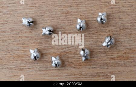 Top view of several small split shot sinkers for fishing on a wood background. Stock Photo