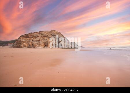Beautiful sandy ocean beach and cliff at the sunset. Panorama atlantic coastline. Stock Photo