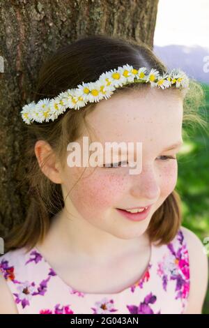 Nine year-old girl with a daisy chain on her head in the shape of a crown. UK. (123) Stock Photo