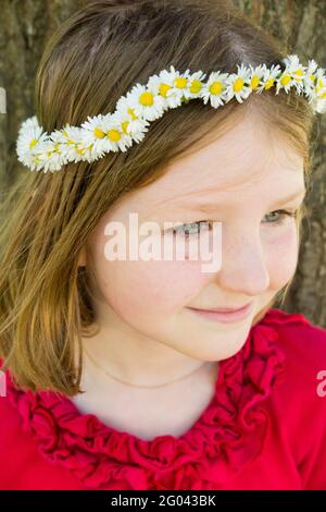 Six year-old girl with a daisy chain on her head in the shape of a crown. UK. (123) Stock Photo