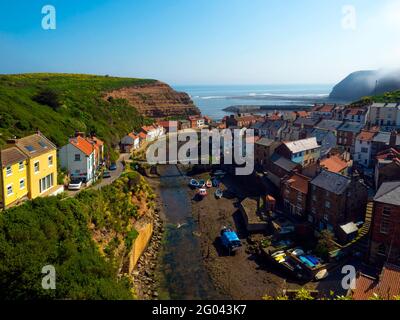 View looking seawards over the harbour of the North Yorkshire Village of Staithes with Cowbar on the North side of Roxby Beck Stock Photo