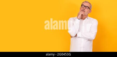 isolated senior adult man with glasses thinking Stock Photo