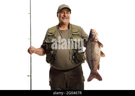 Smiling mature fisherman holding a fishing rod and a big carp fish isolated  on white background Stock Photo - Alamy