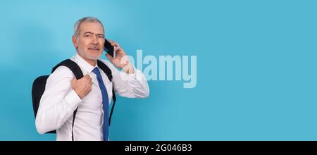 businessman with mobile phone and backpack isolated on background Stock Photo
