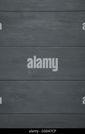 Natural wooden background painted in black. Vertical view. The texture of the tree. Stock Photo