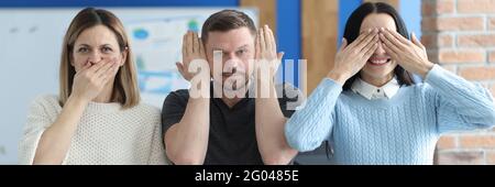 Man and women covering their mouths, eyes and ears with hands Stock Photo