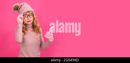 attractive adult woman with mobile phone isolated wearing warm clothes Stock Photo