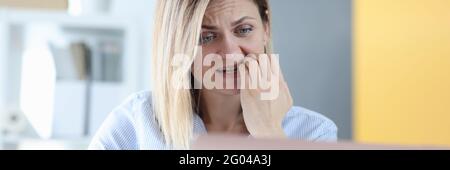 Frightened woman looks into laptop monitor closeup Stock Photo