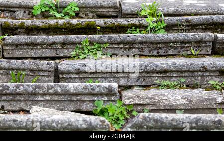 Close. The ancient stairs cracked in half. stone stairs. Covered with grass. Stock Photo