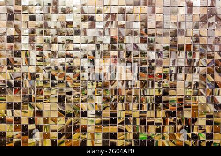 Small squares. Ceramic glass gold tile mosaic composition pattern background. Photophone. Wedding decor. Stock Photo