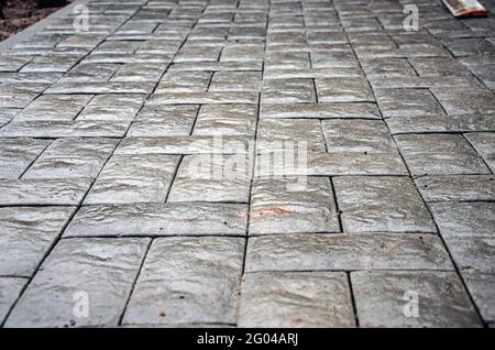 Abstract background of old cobblestone pavement close-up. Stock Photo