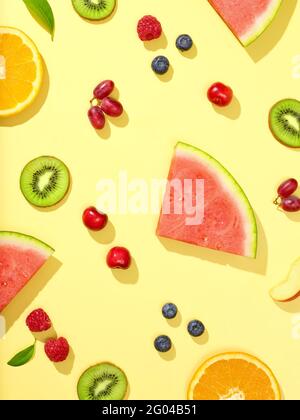 various fresh fruit and berries on yellow background, top view Stock Photo