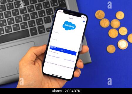 Kharkov, Ukraine - May 28, 2021: Man hold mobile phone with the Salesforce app title screen Stock Photo