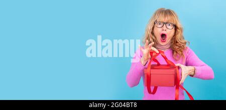 woman opening gift box with surprise Stock Photo