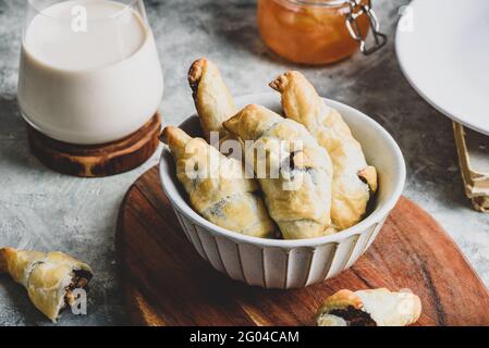 Bowl of fresh baked croissants stuffed with nuts and chocolate spread Stock Photo